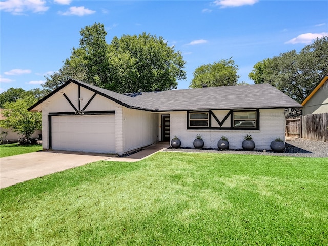 view of front of property featuring a garage and a front yard