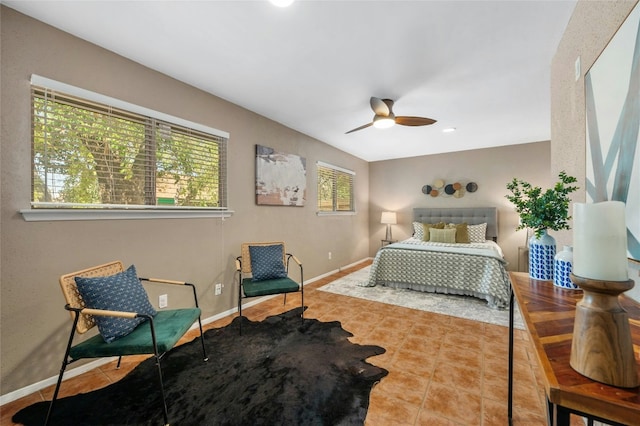 tiled bedroom featuring ceiling fan