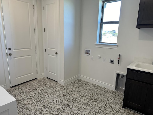 washroom featuring cabinets, hookup for a gas dryer, sink, washer hookup, and hookup for an electric dryer