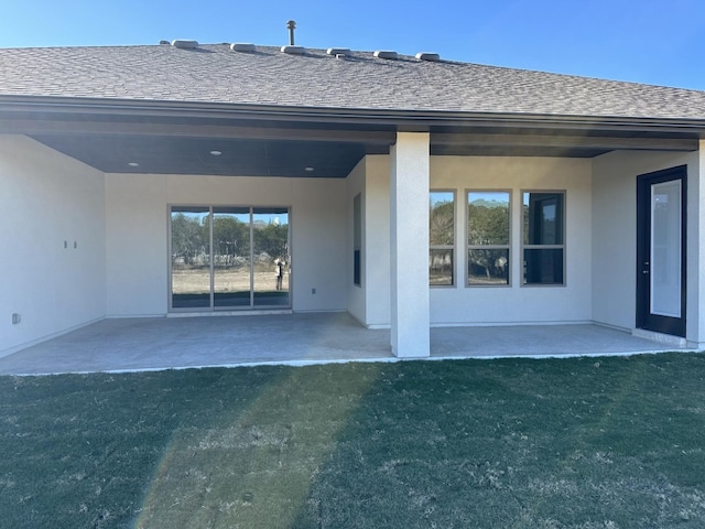 back of house featuring a yard and a patio