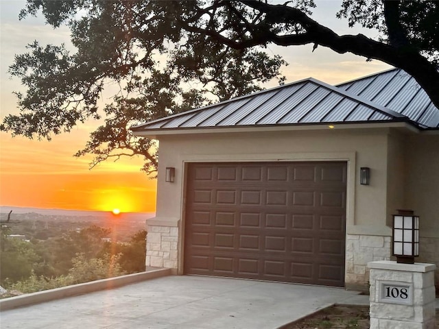 view of garage at dusk