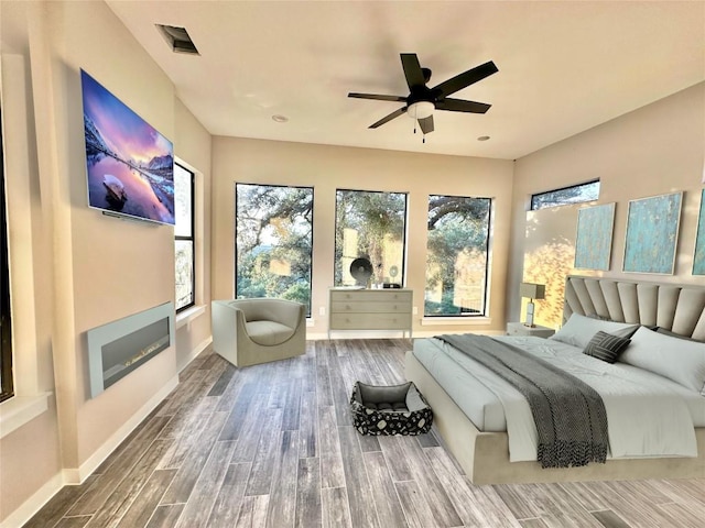 bedroom with ceiling fan and hardwood / wood-style floors