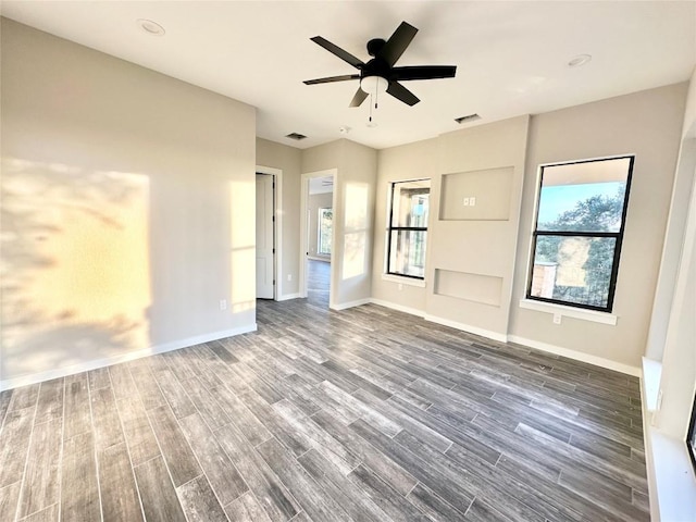 interior space with ceiling fan and dark wood-type flooring