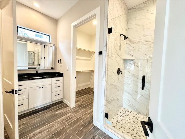 bathroom with vanity and a shower with door