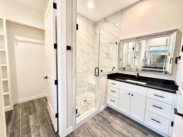 bathroom with vanity and a shower with shower door