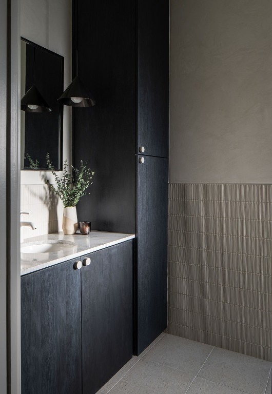 bathroom with tile walls, sink, and tile patterned floors