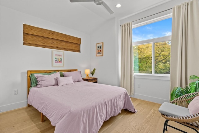 bedroom with a ceiling fan, light wood-style flooring, recessed lighting, baseboards, and vaulted ceiling
