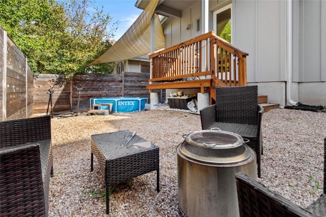 view of patio featuring a fire pit and fence