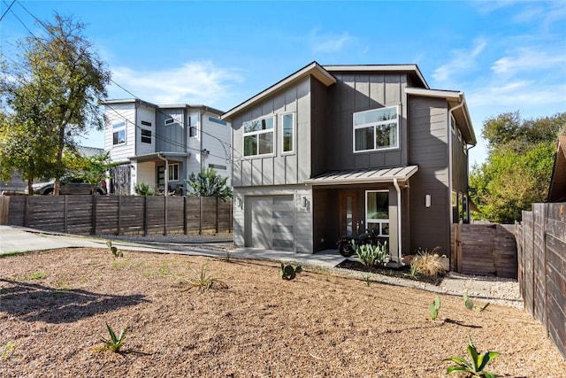 back of property featuring fence private yard, driveway, a garage, and board and batten siding