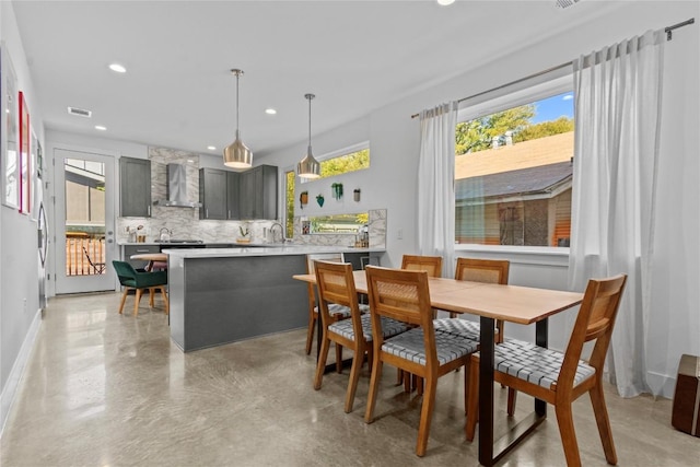 dining space featuring finished concrete floors, baseboards, visible vents, and recessed lighting