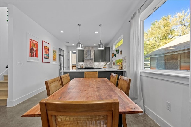 dining area featuring stairway, concrete flooring, baseboards, and recessed lighting