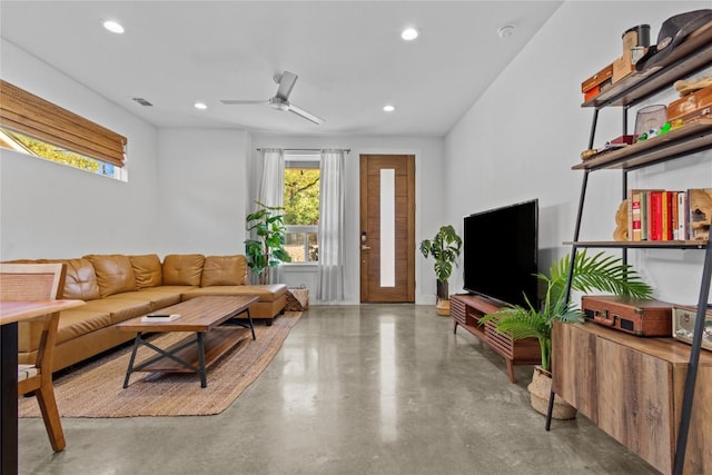 living room with ceiling fan, concrete flooring, visible vents, and recessed lighting
