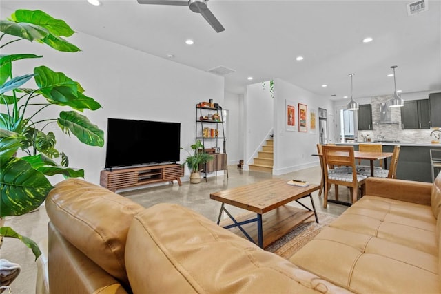 living area with baseboards, recessed lighting, and a ceiling fan