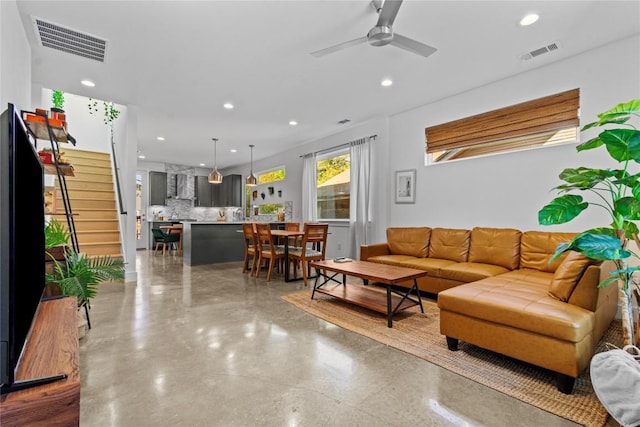 living area with stairs, recessed lighting, and visible vents