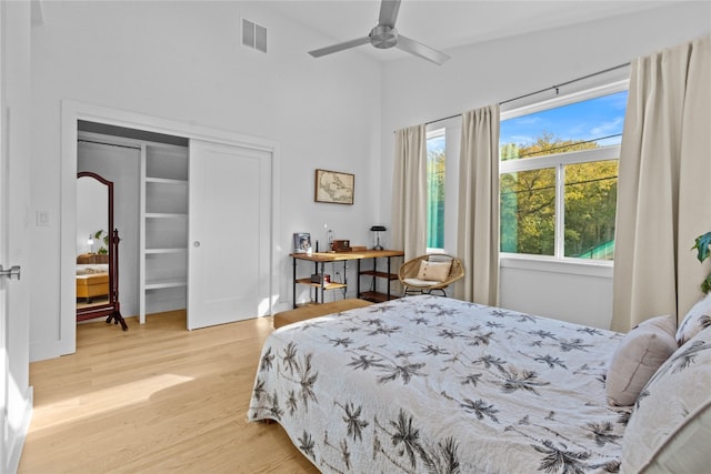 bedroom featuring vaulted ceiling, light hardwood / wood-style flooring, a closet, and ceiling fan