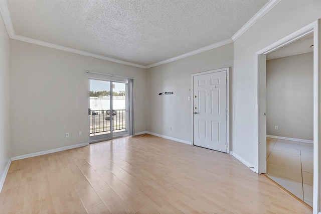 unfurnished room with a textured ceiling, light hardwood / wood-style flooring, and crown molding