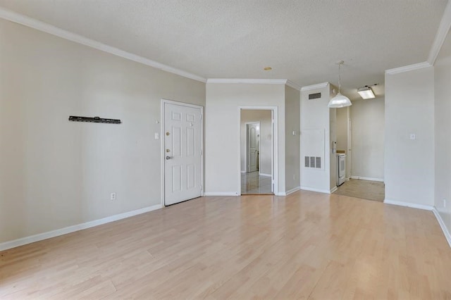 unfurnished room with ornamental molding, light wood-type flooring, and a textured ceiling