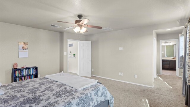 bedroom with light carpet, ensuite bath, and ceiling fan