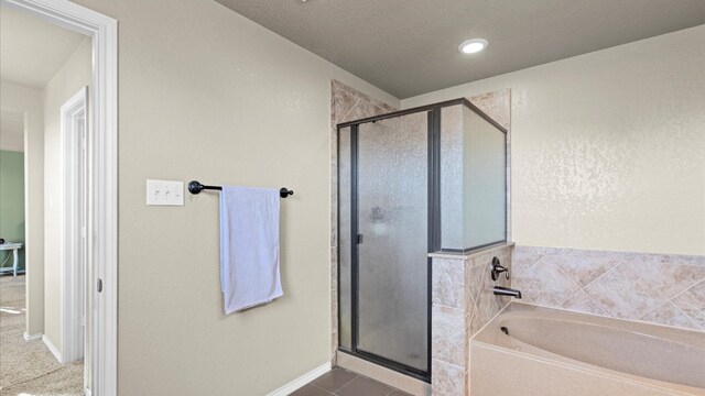 bathroom featuring tile patterned floors and independent shower and bath