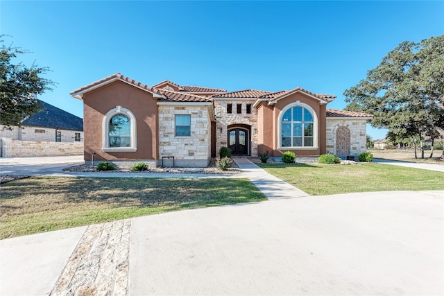 mediterranean / spanish-style home featuring a front lawn