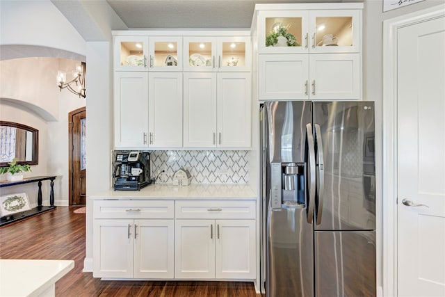 kitchen with white cabinets, stainless steel fridge, a textured ceiling, backsplash, and dark hardwood / wood-style flooring