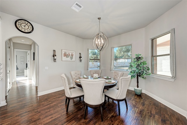 dining space with an inviting chandelier and dark wood-type flooring