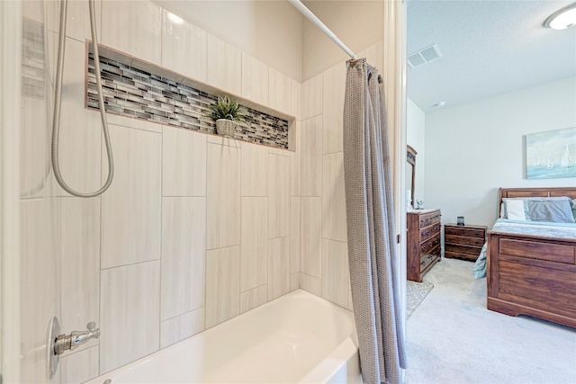 bathroom with a textured ceiling and shower / bath combo with shower curtain