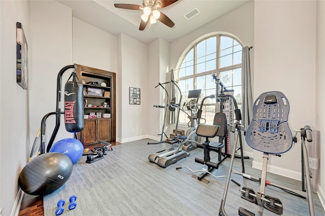 workout area with hardwood / wood-style flooring and ceiling fan