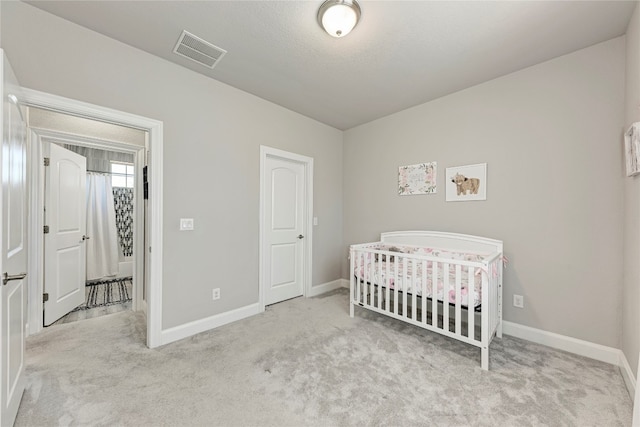 bedroom with light carpet and a crib