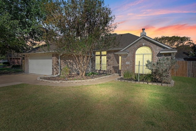 view of front facade with a garage and a lawn