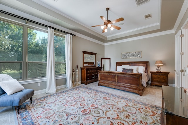 bedroom featuring a tray ceiling, ceiling fan, and crown molding