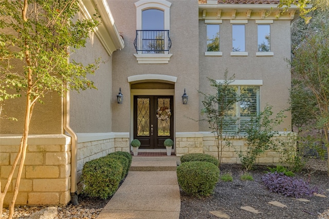 property entrance with french doors and a balcony