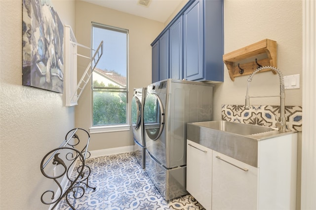 washroom featuring sink, light tile patterned floors, and washer and dryer