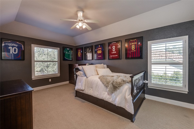 bedroom with ceiling fan, light carpet, and vaulted ceiling