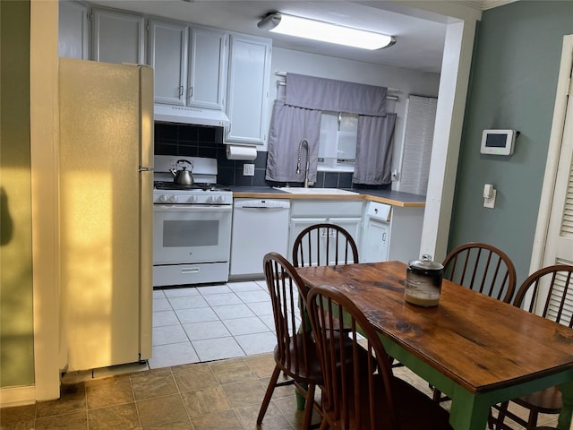 kitchen featuring tasteful backsplash, white appliances, sink, and white cabinets