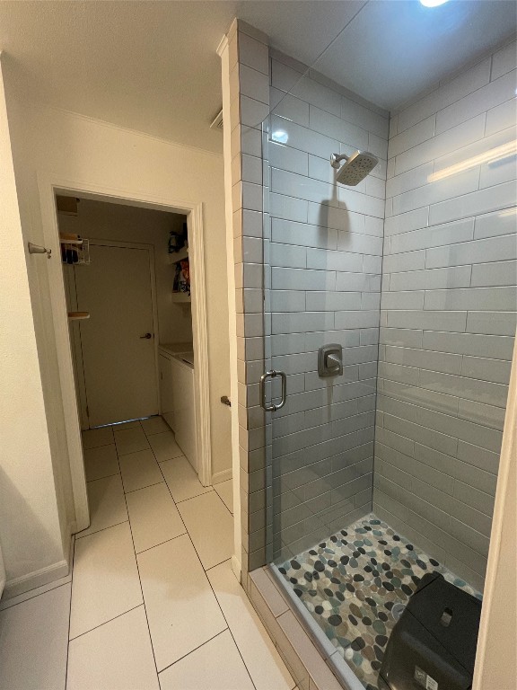 bathroom featuring a shower with door and tile patterned floors