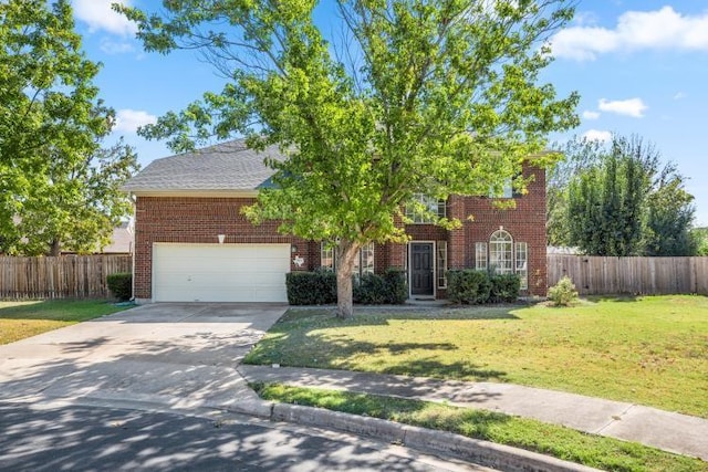 view of front of home with a front lawn and a garage