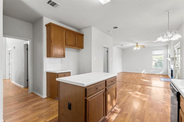 kitchen featuring tasteful backsplash, light hardwood / wood-style flooring, a kitchen island, and pendant lighting