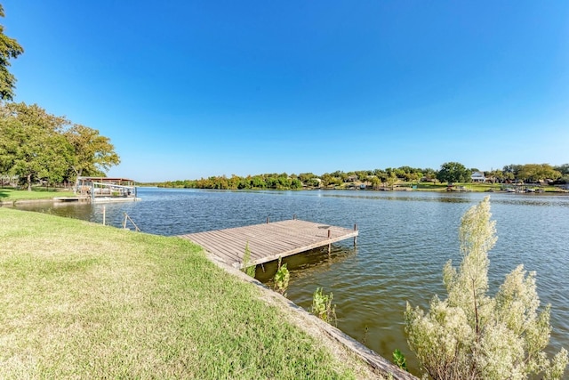 view of dock featuring a water view and a yard