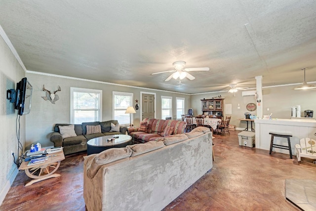 living room with ceiling fan, a textured ceiling, ornamental molding, and concrete flooring