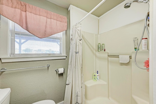 bathroom with a shower with curtain and toilet