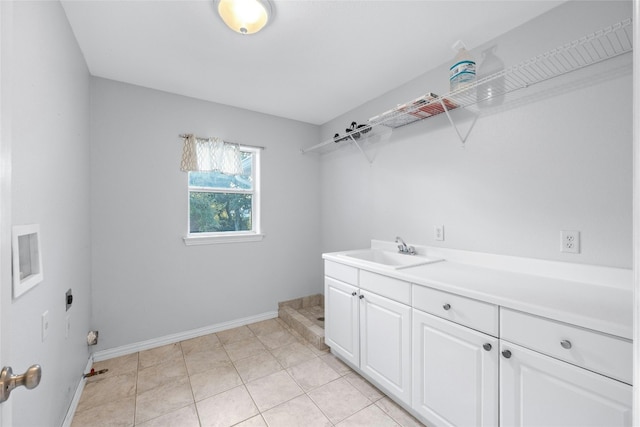 washroom with cabinets, sink, light tile patterned floors, and electric dryer hookup