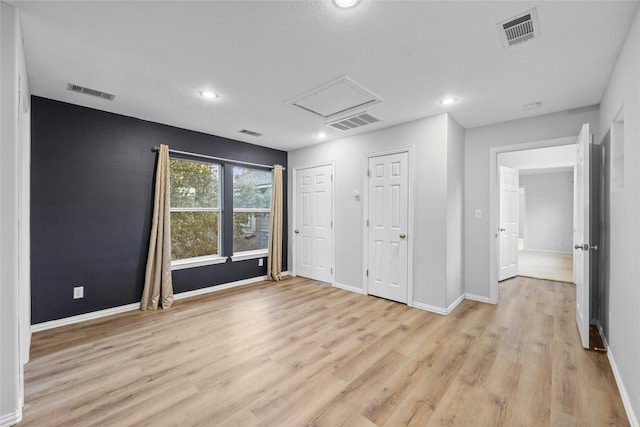 spare room with light wood-type flooring