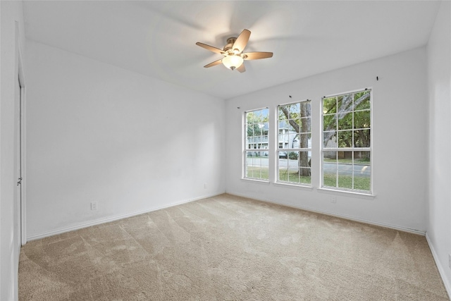 carpeted empty room featuring ceiling fan