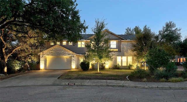 view of front facade with a garage and a yard