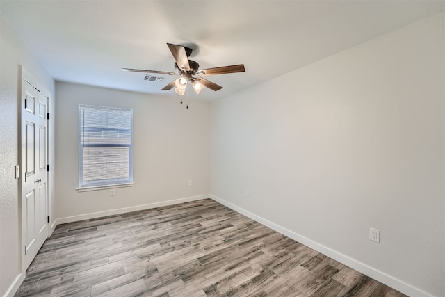 empty room featuring ceiling fan and light hardwood / wood-style floors