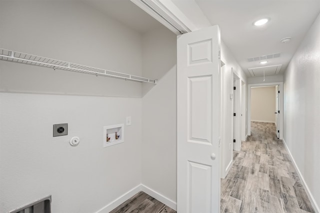 washroom with hookup for a washing machine, hookup for a gas dryer, light hardwood / wood-style flooring, and electric dryer hookup