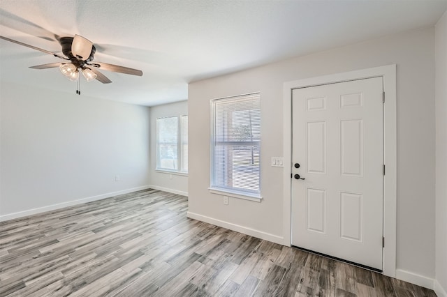 entryway with ceiling fan and light hardwood / wood-style floors