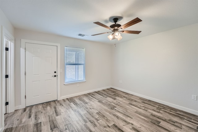 spare room with light hardwood / wood-style flooring and ceiling fan