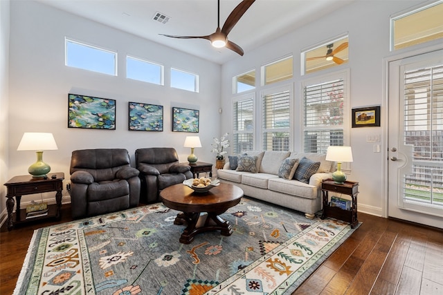 living room with dark wood-type flooring and ceiling fan